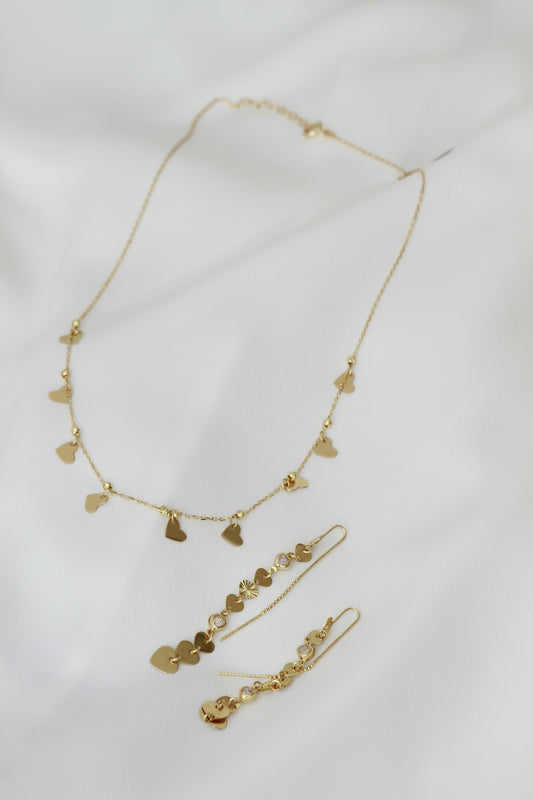 A necklace and earring set on a white sheet