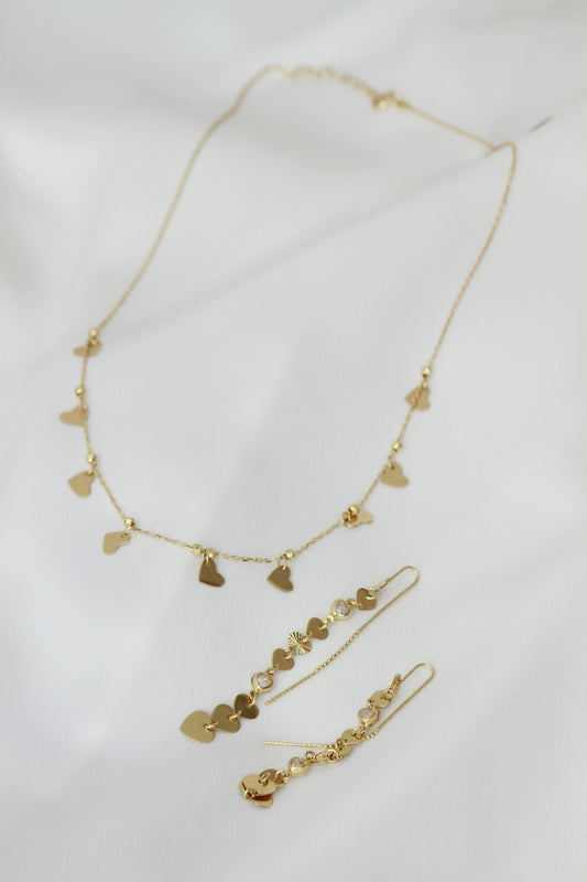 A necklace and earring set on a white sheet